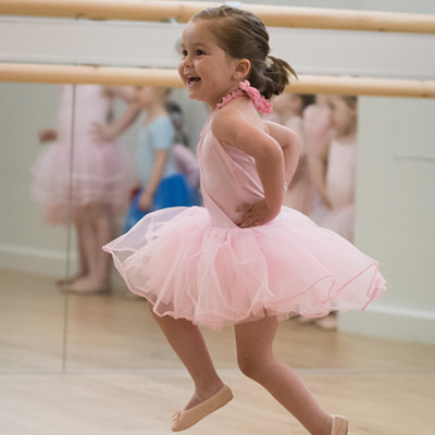 Ballet girl smiling and dancing